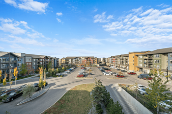an aerial view of an apartment complex with a parking lot